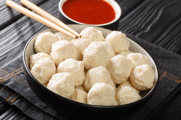 Chicken Meat Balls Bakso Ayam with sauce close up in the bowl on the table. Horizontal