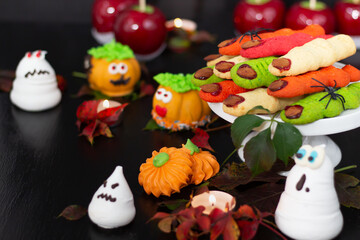 Captivating Halloween dessert tableau, showcasing gleaming candy apples, whimsical marzipan faces, and ghostly treats, evoking autumn festivities.