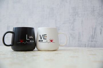 Love mug cup white backgrounds . White and black colored cup I love you . Mr. Handsome Mrs. Beautiful couple mug . Picture of heart and pulse . Azerbaijan Baku . 25.04.2021 .