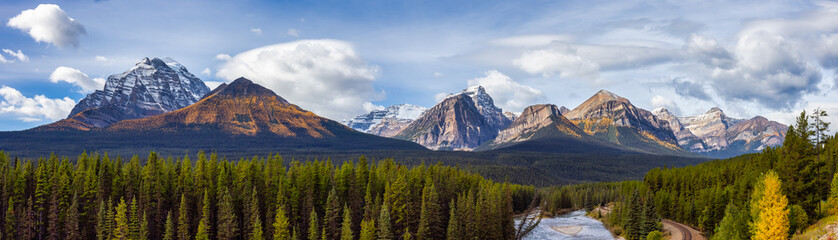Panoramic View of Canadian Rocky Mountain Landscape. Fall Season Cloudy Sunny Sky. Lake Louise, Banff National Park, Alberta, Canada. Nature Background Panorama