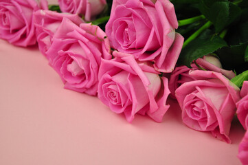 Bouquet of roses on pink background copy space 