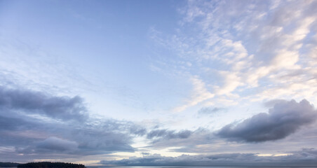 View of colorful cloudscape during dramatic Sunrise. Taken on West Coast of Vancouver Island,...