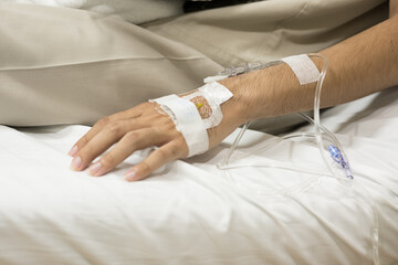 Fototapeta premium Close up set iv fluid intravenous drop saline drip for accident and seriously patient in hospital room.Medical treatment emergency patient.Medical treatment and cure concept.