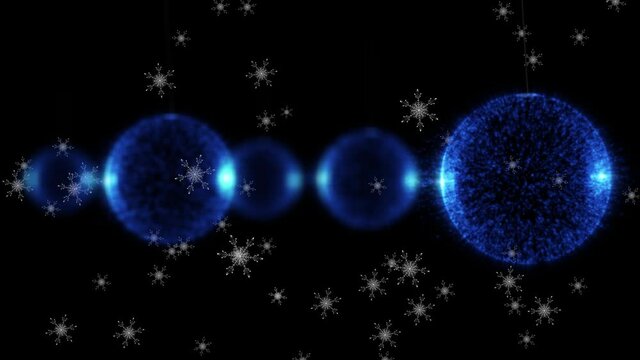 Animation of snow falling over christmas baubles on black background