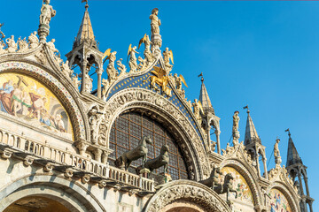 Detail of the façade of Saint Mark's Basilica in Saint Mark's Square with sculptures and the Byzantine bronze statues of four horses, Venice, Italy, Europe