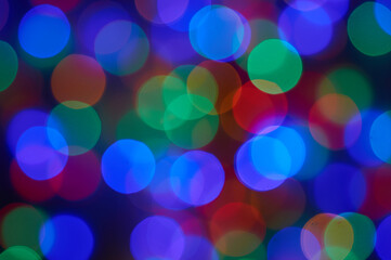 Blurred photo bokeh multicolored christmas lights .
