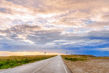 Amazing highway landscape at dawn with dramatic sky