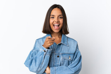 Young latin woman isolated on white background surprised and pointing front
