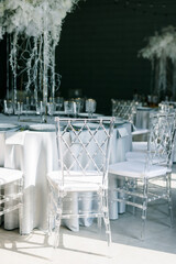 Transparent plastic Chiavori chairs for guests on the street close-up. Autumn wedding ceremony on the street on the green lawn.
