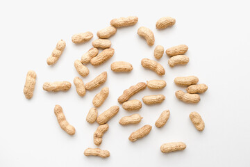 Peanuts on a white background. Unpeeled peanuts. Peanuts in shells. 