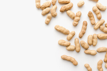 Peanuts on a white background. Unpeeled peanuts. Peanuts in shells. 