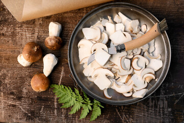 Flat lay composition with mushrooms and knife on wooden table