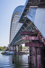 Construction of a large arched bridge in the capital of Ukraine. Podolsky bridge, panoramic view of the bridge under construction across the Dnipro, clear weather, summer. Kyiv