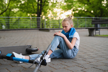 Electric scooter accident - girl suffering of pain after knee injury © blackday