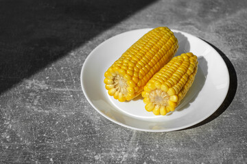 organic cooked corn on a white plate on the table. healthy food. vegetarian breakfast