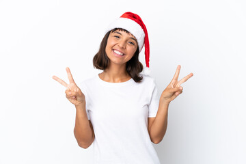 Obraz na płótnie Canvas Young mixed race woman celebrating Christmas isolated on white background showing victory sign with both hands