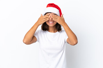 Young mixed race woman celebrating Christmas isolated on white background covering eyes by hands
