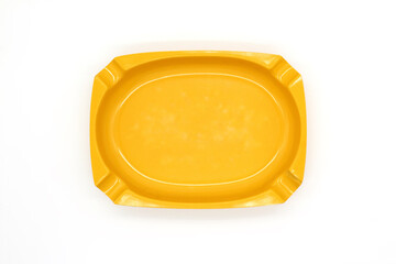 Vintage yellow porcelain empty ashtray isolated on a white background, close up