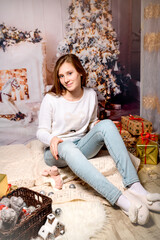 Christmas Child , Happy girl sitting front of Xmas Tree with gifts