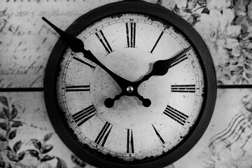 Old vintage clock on a wooden background.  Round dial of the wall clock. Black and white classic photo. Concept Time runs. time concept.  watch, timepiece, timer, timekeeper, ticker.