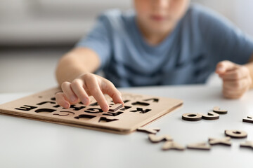 Cropped of kid playing with educational game, collacting letters