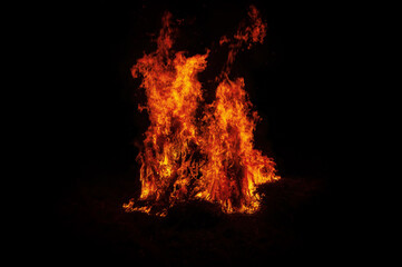 Hearth is fully. Black background. Flame of fire flame texture for background