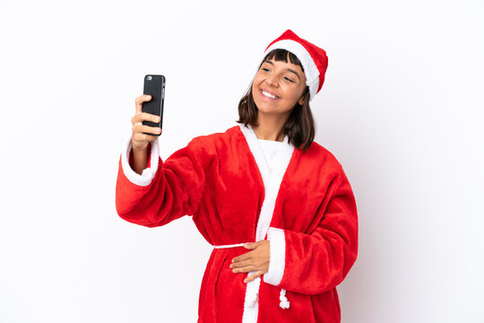 Young mixed race woman disguised as Santa Claus isolated on white background making a selfie