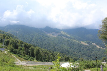 mountains clouds green forest