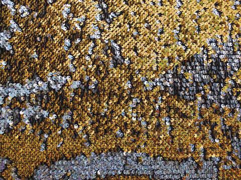 Background or texture of holographic golden and silver sequins