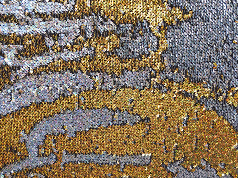 Background or texture of holographic golden and silver sequins