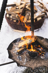 Firewood burning inside the fire-pit during cold winter day