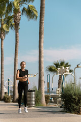 Athletic woman is running during her summer jogging workout