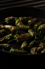 Fried Green Standard Peppers with olive oil, garlic and sea salt, a traditional Spanish tapas recipe.