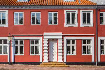 Fototapeta na wymiar Red facade of a historic house in the center of Ribe, Denmark
