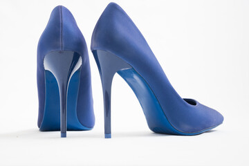A pair of blue high-heeled shoes. Suede women's elegant shoes on a white background. Beautiful high and feminine heel