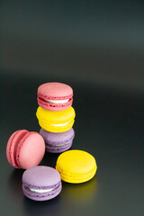 colorful macarons on black background