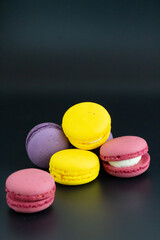 colorful macarons on black background