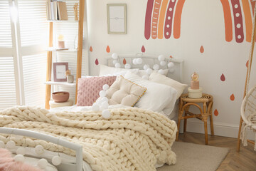 Stylish child's room interior with comfortable bed
