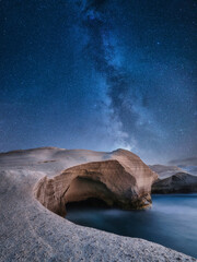 Rocks and galaxy. Long exposure. Rocks on the seashore. Stars on the dark sky. Photo as wallpaper....