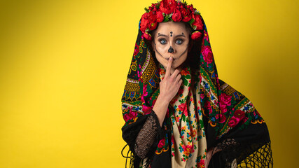 girl in the image of Kalavera Katrina close up showing various emotional body gestures, in a headscarf, on a yellow background. Dia-de -los -muertos. Day of death. Halloween.