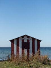 Red and white striped Beach House in Ærøskøbing on the island of Ærø or Aroe in Denmark. The changing room / hut / cabin is called Vandhytten or water hut.