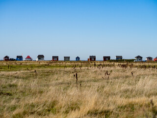 Beach Houses on a row in Ærøskøbing on the island of Ærø or Aroe in Denmark. Field in foreground