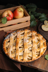 Delicious traditional apple pie on wooden table