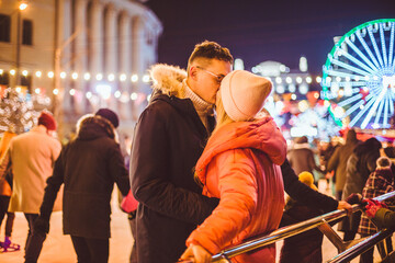 Couple in Love. Romantic Characters for Feast of Saint Valentine. True love. Happy Couple Having Fun at city ice rink in the evening. Happy romantic young couple enjoying together in skating-rink