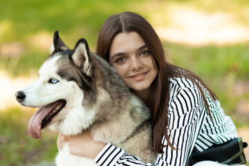 The girl hugs her furry friend. The teenager poses for a photo. The dog and it's owner.