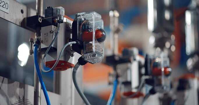 Inside a new modern plant, in a production workshop with technological lines, pipelines, valves, electrics, and other equipment in the infrastructure of a just built wood processing complex 