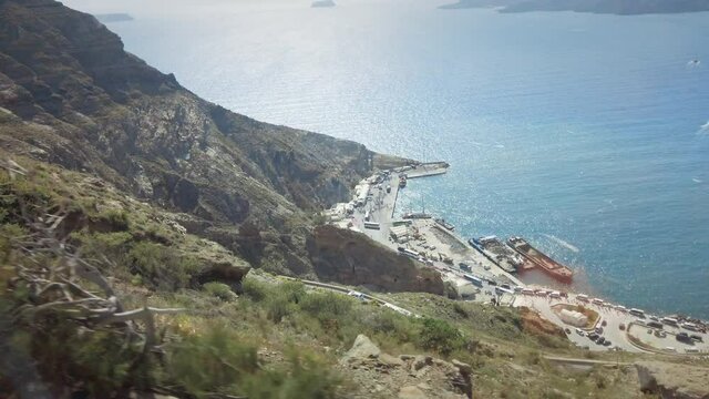 Pov drive on Hairpin road to Athinios port and Aegean sea, Santirini island.