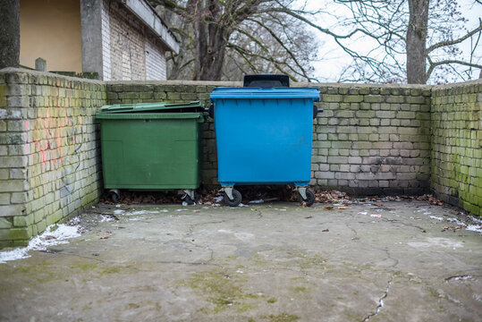 Two green and blue recycling containers outside, Latvia