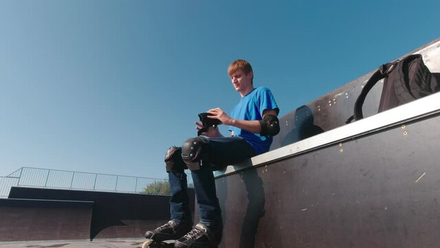 Man in a skatepark in protection on roller skates
