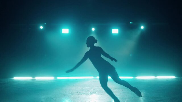 Figure skater is practicing jumps on the rink